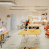 Shared sewing studio with cutting table and machines