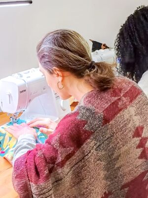 Participant of beginner sewing workshop at the sewing machine
